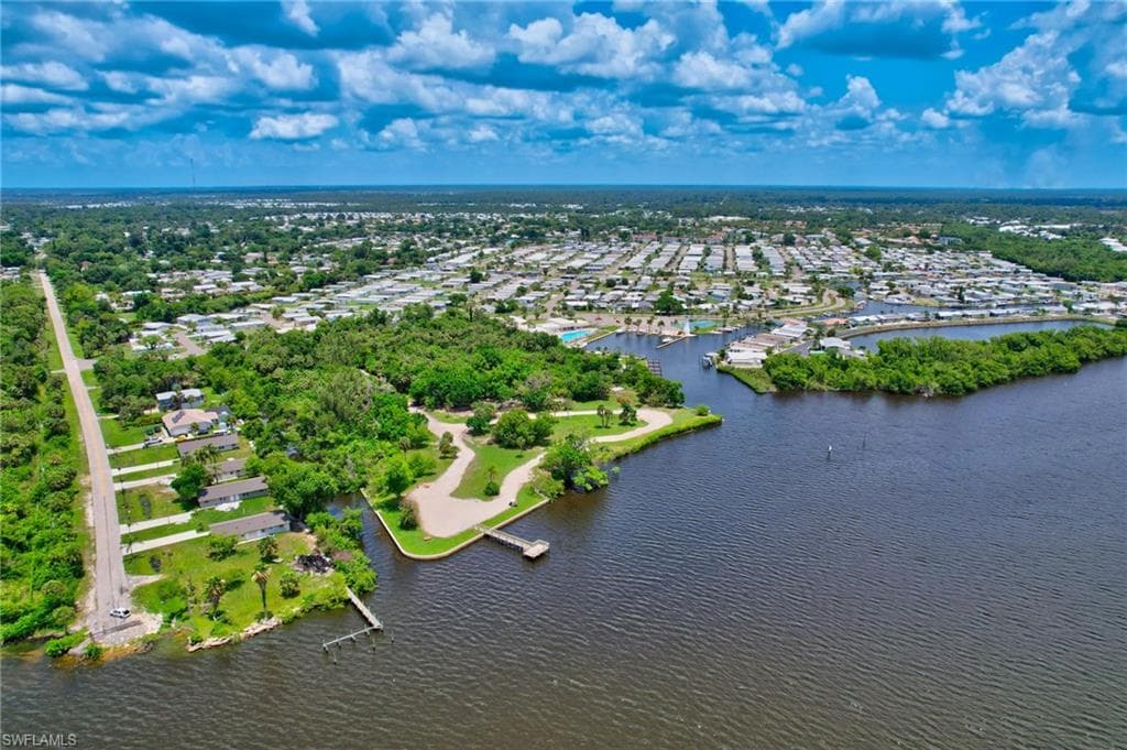Aerial perspective of suburban area featuring a nearby body of water