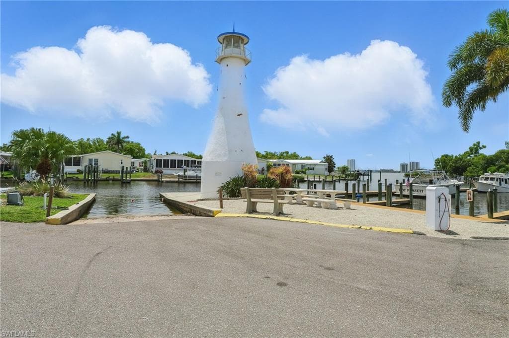 View of community featuring a boat ramp, a boat dock, and a water view