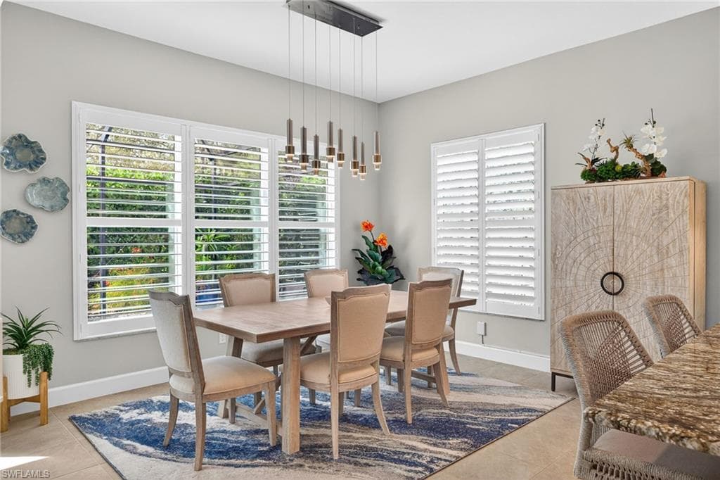 This dining area seats 8 easily, and is flooded with light due to the 5 windows adorned with plantation shutters PLUS the left wall of zero corner sliding doors and coordinating lighting to the island lighting.