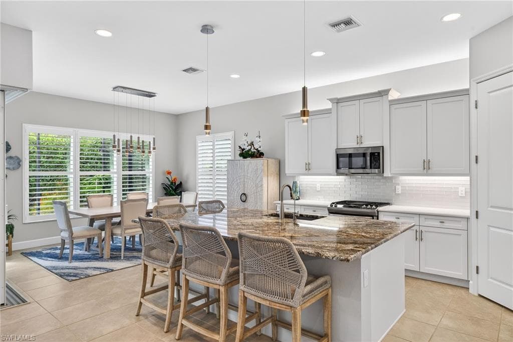 This GORGEOUS island's granite countertop serves as the focal point of this amazing kitchen w/ corner walk-in pantry, coffee bar area, soft close drawers, and a chef's delight!