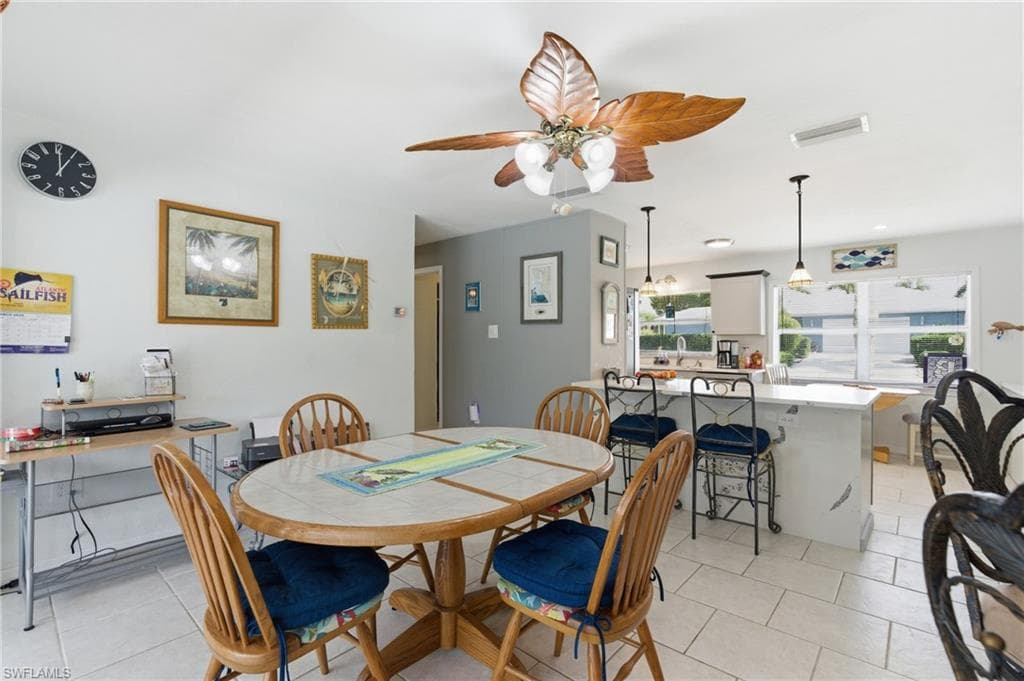 Dining area featuring a ceiling fan and light tile patterned flooring