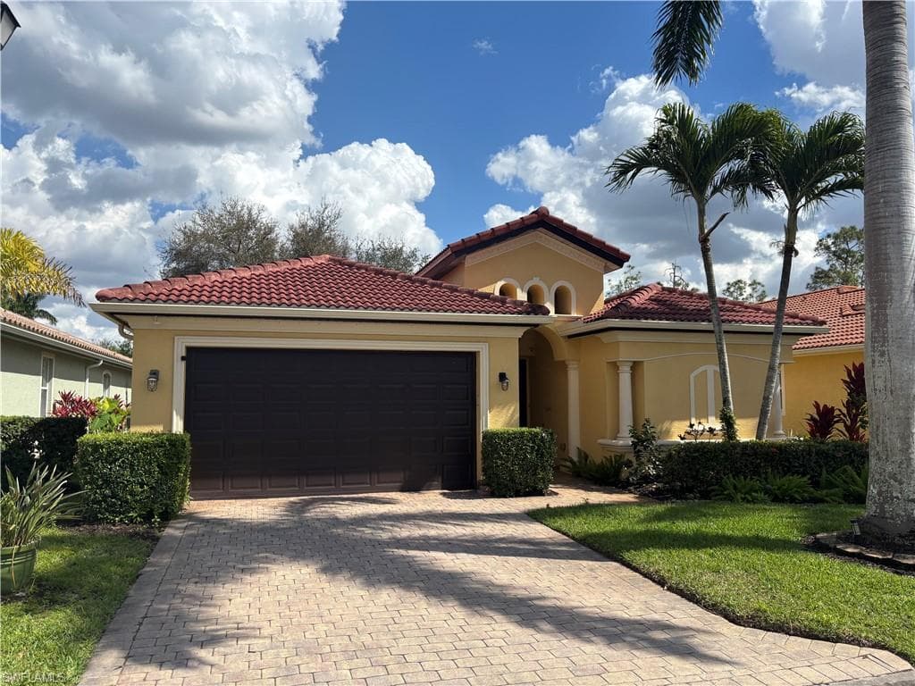 Mediterranean / spanish-style home featuring stucco siding, a garage, decorative driveway, and a tile roof
