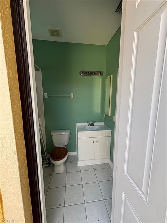Bathroom featuring vanity, a shower, and light tile patterned flooring