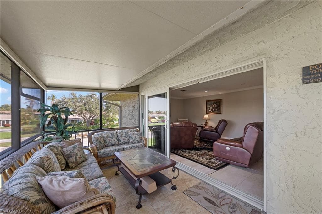 Sunroom / solarium with tile patterned floors and ornamental molding