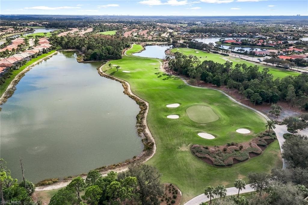 Aerial view of residential area with a large body of water and a local golf course