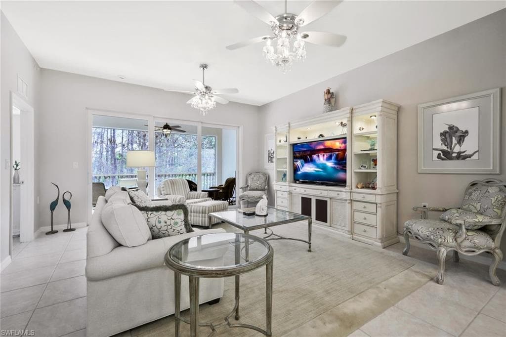 Living room featuring a ceiling fan and light tile patterned floors