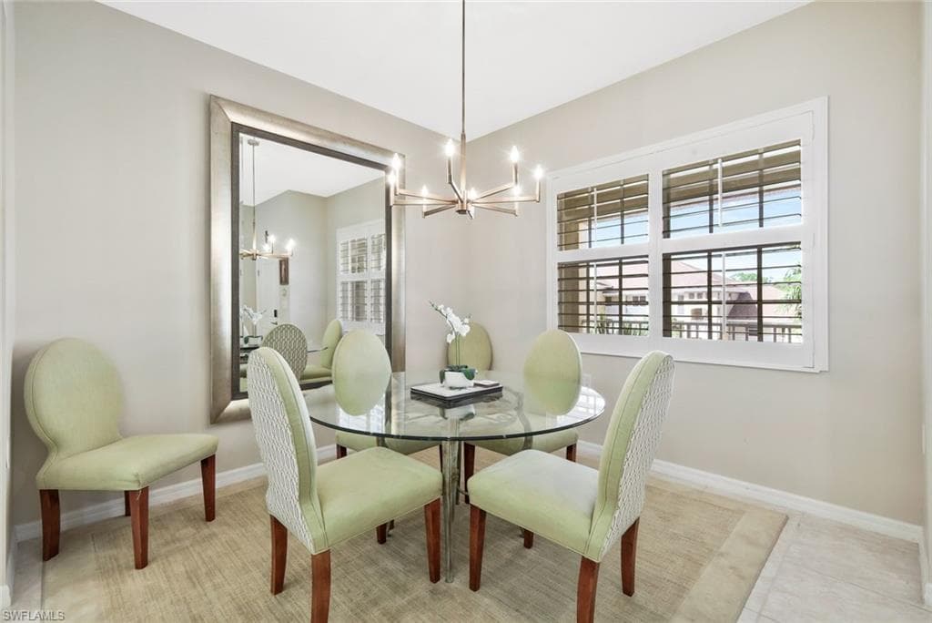 Dining area featuring suspended lighting and baseboards