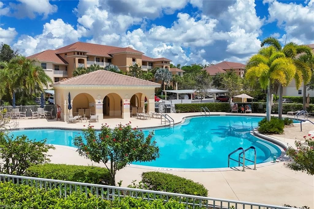Community pool with a patio