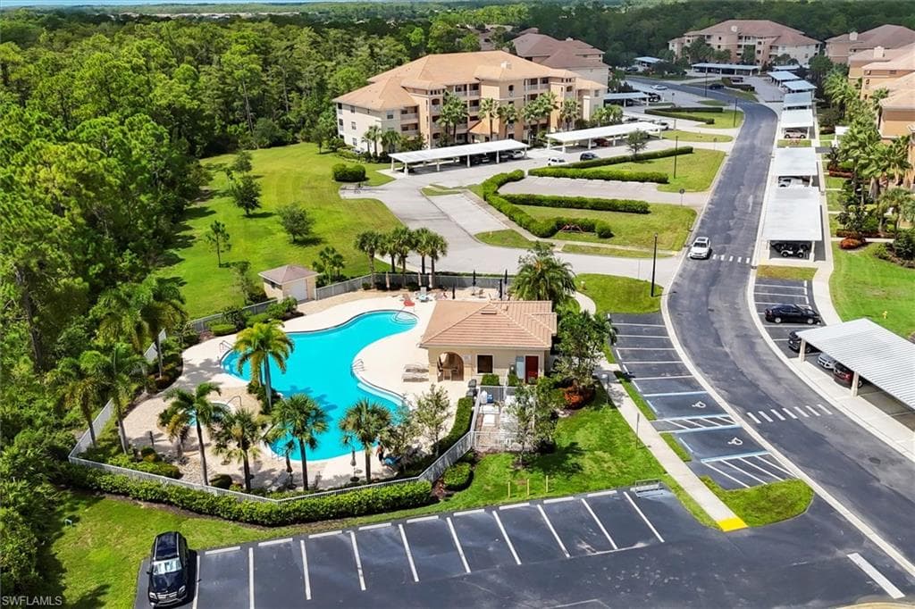 Bird's eye view of a pool and a heavily wooded area