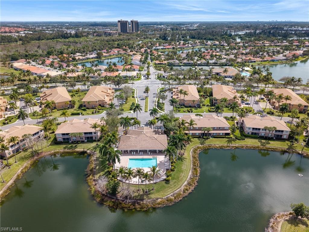 Aerial view of property and surrounding area with a large body of water