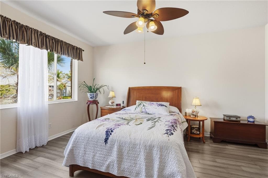 Bedroom with light wood-type flooring and a ceiling fan