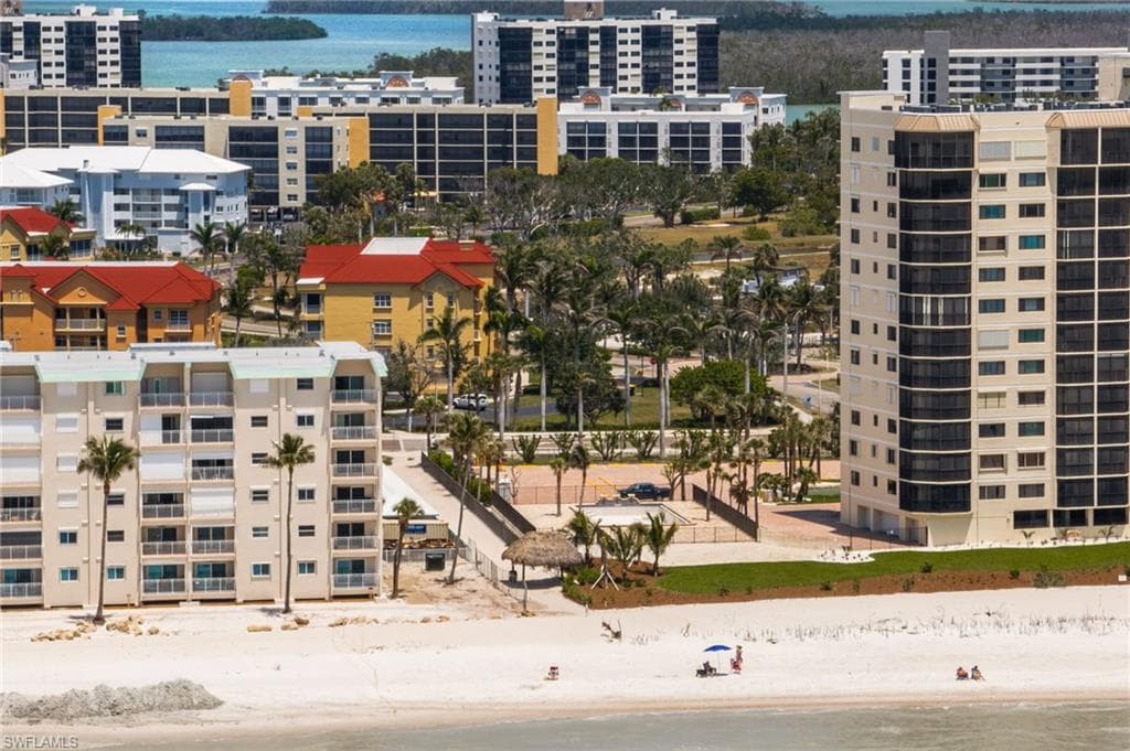 Aerial view of extended coastline and apartment complex / building
