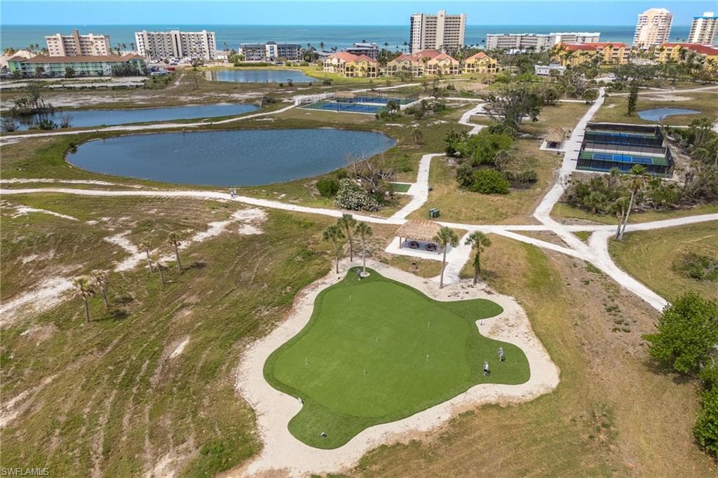 View of urban area featuring a large body of water and a golf club