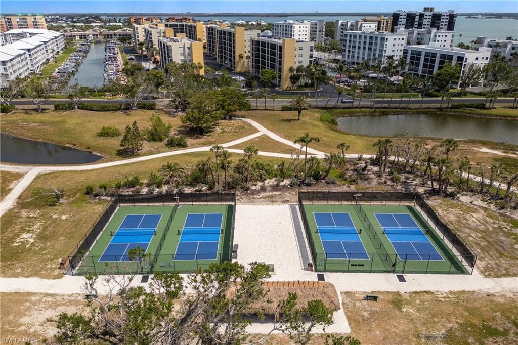 Drone / aerial view of apartment complex and a large body of water