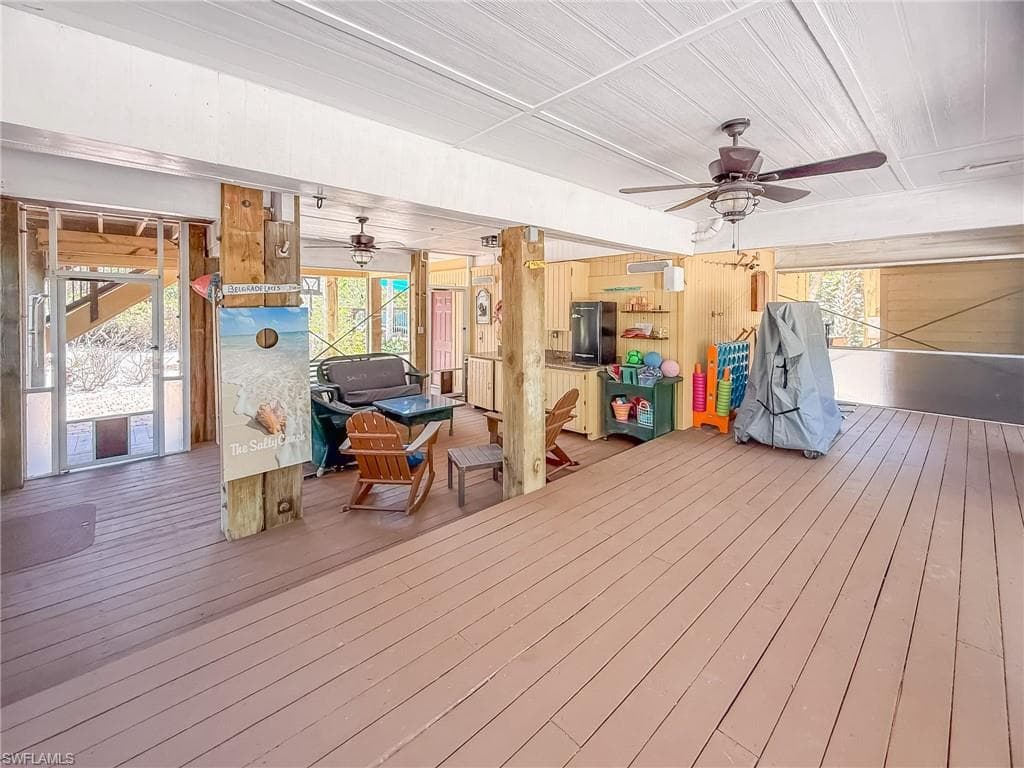 Wooden terrace featuring a ceiling fan