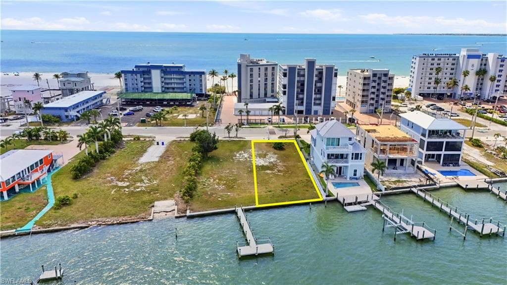 Aerial overview of property's location with a large body of water and property boundaries highlighted - Virtually Edited Image