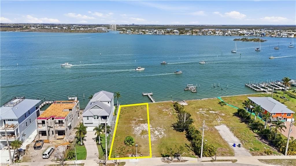 Aerial view of residential area featuring property parcel outlined - Virtually Edited Image