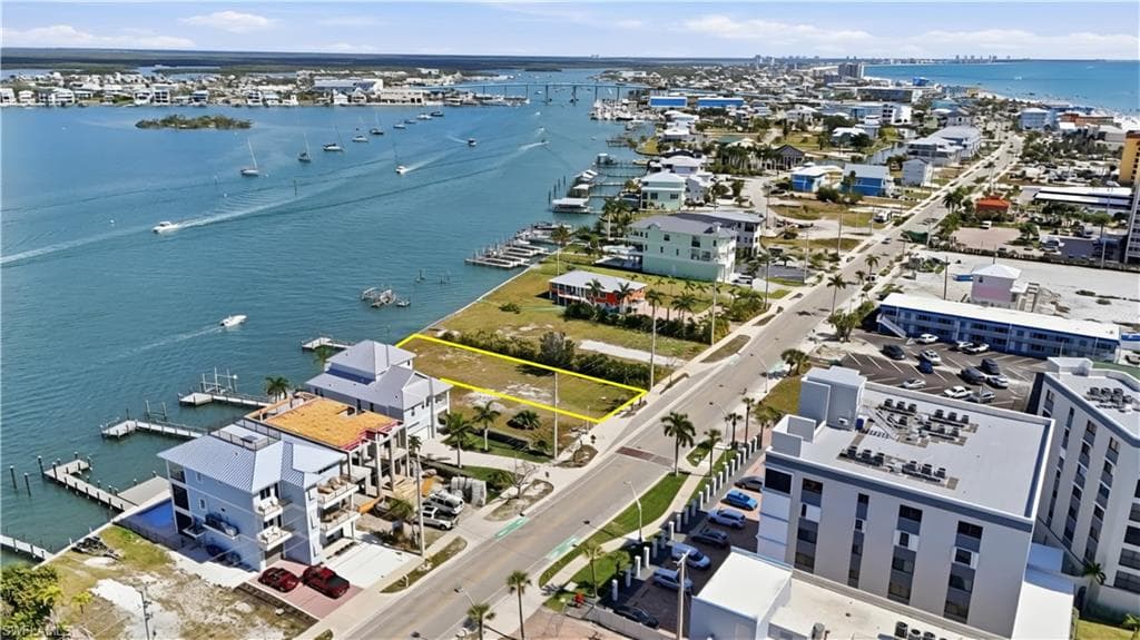 View of property location with a large body of water and property parcel outlined - Virtually Edited Image