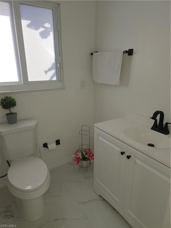Bathroom with vanity and light marble finish floors