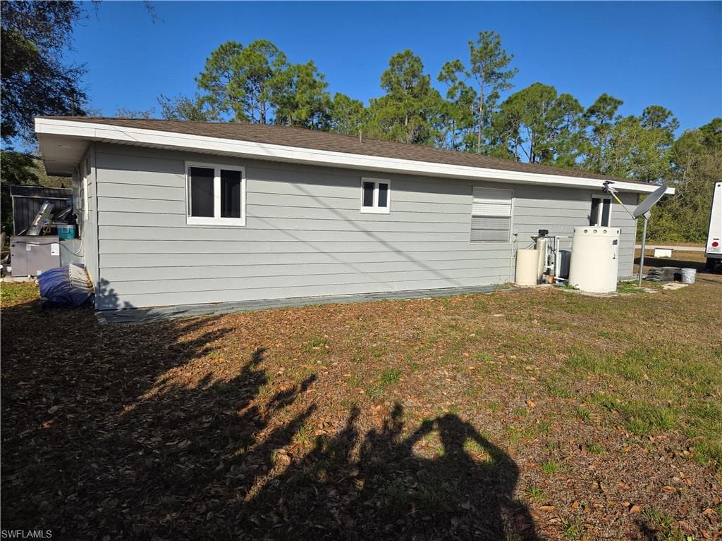 Back of property featuring a lawn