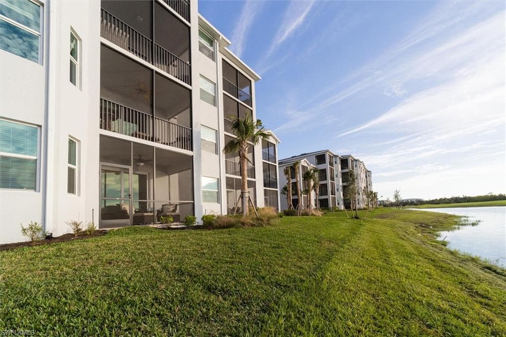 View of apartment building / complex featuring a water view