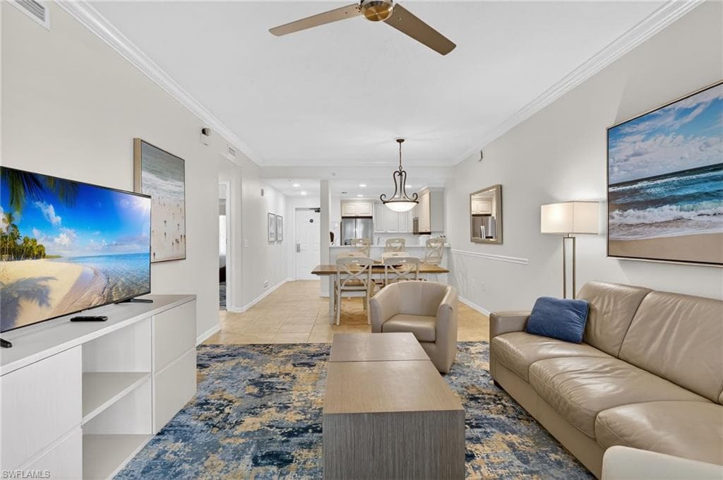 Living room featuring crown molding, ceiling fan, light tile patterned flooring, and recessed lighting