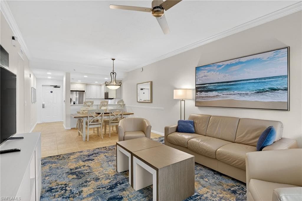 Living area featuring crown molding, a ceiling fan, light tile patterned flooring, and recessed lighting