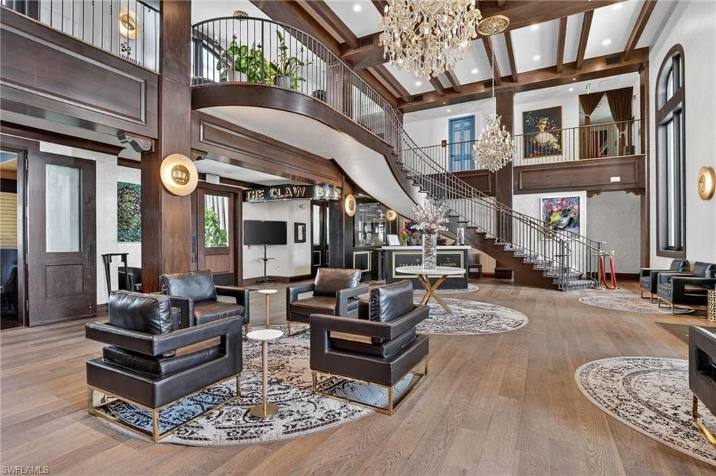 Living area with suspended lighting and wood-type flooring