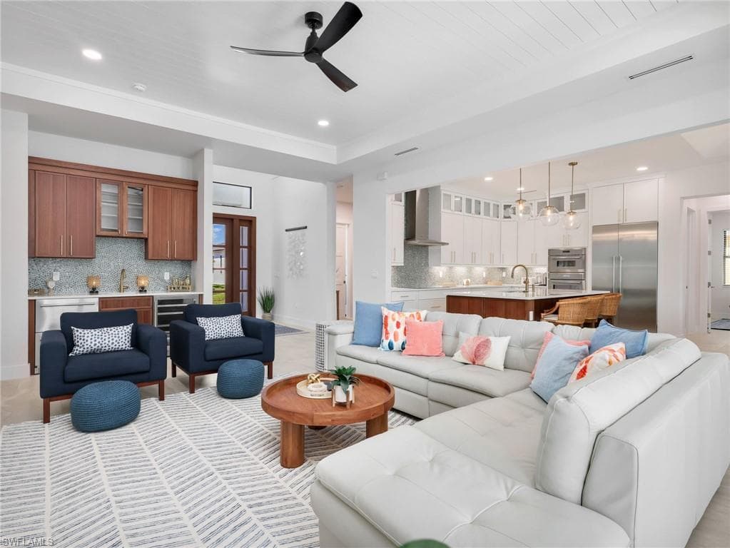 Living area featuring bar, a ceiling fan, recessed lighting, and wine cooler