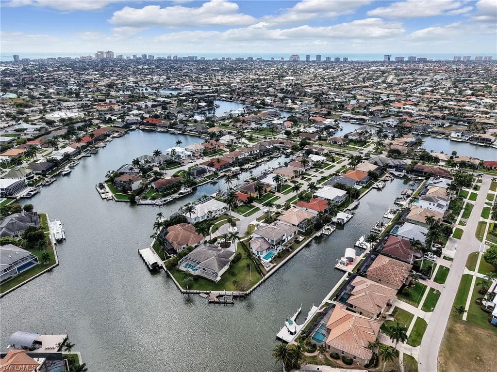 Aerial view of residential area with a nearby body of water and skyline
