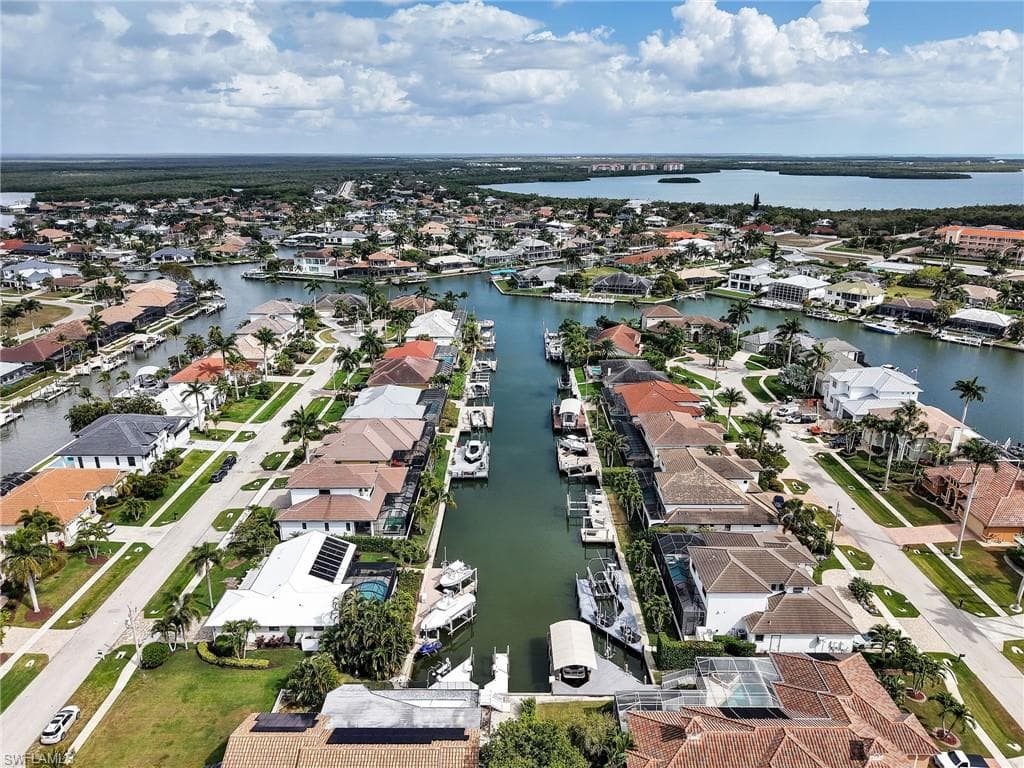 Aerial view of property's location with nearby suburban area and a large body of water