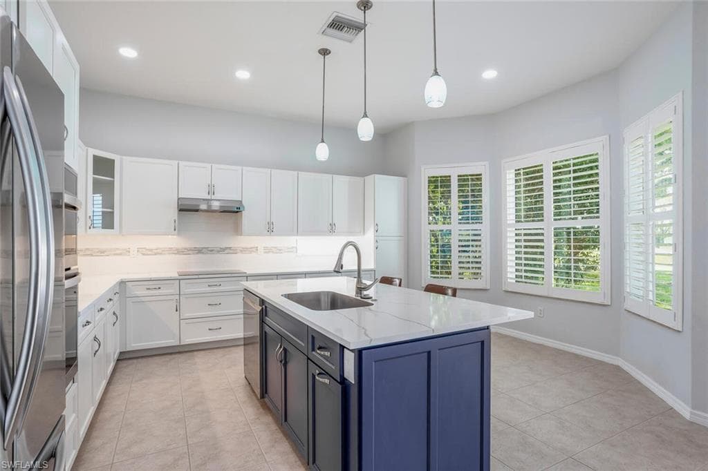 Kitchen w/ Quartz Countertops, Subway Tile Backsplash w/ Decorative Glass, Pendant Lighting