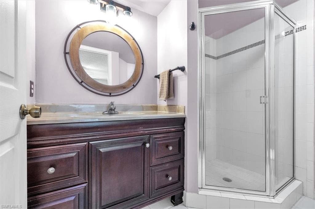 Bathroom with vanity and a shower stall