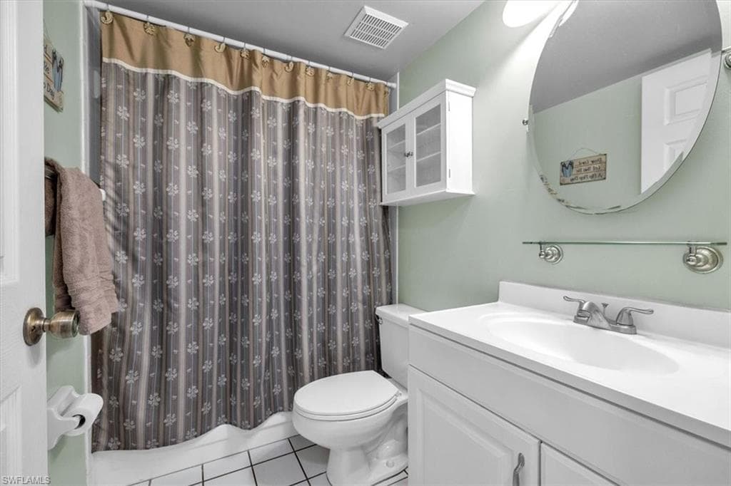 Bathroom with vanity and light tile patterned floors