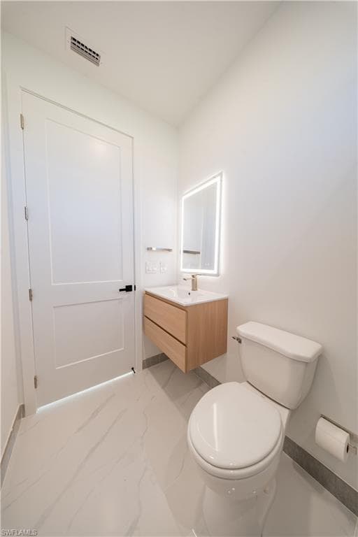 Bathroom with vanity and light marble finish floors