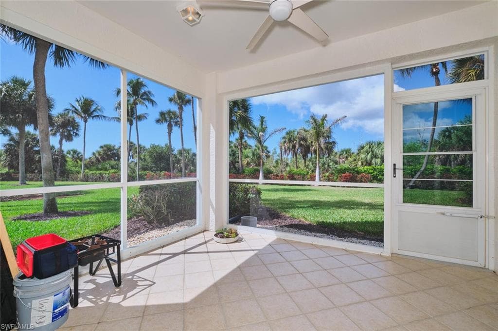 Unfurnished sunroom featuring ceiling fan