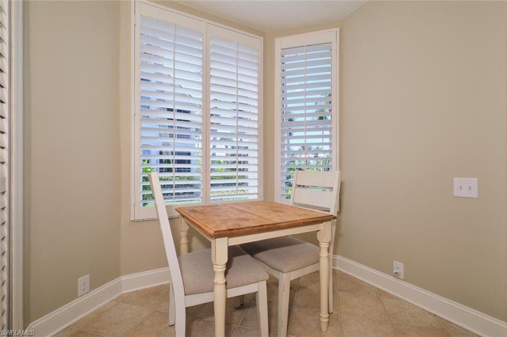 Dining area with baseboards and light tile patterned floors