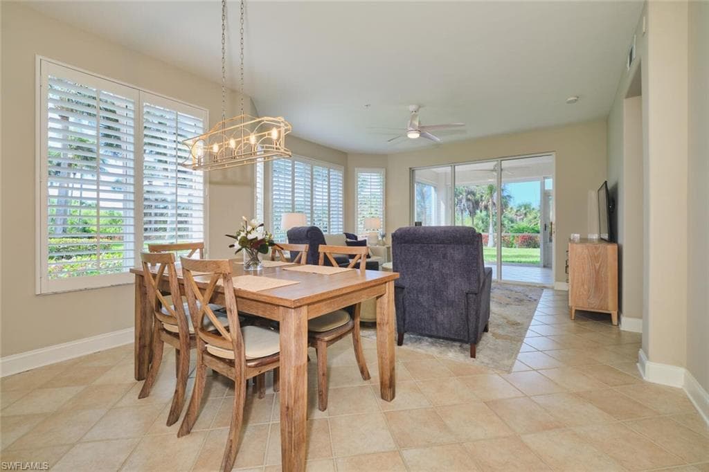 Dining area with a ceiling fan and light tile patterned floors