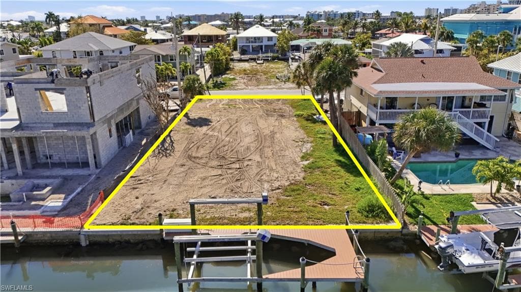 Aerial view of residential area featuring property parcel outlined - Virtually Edited Image