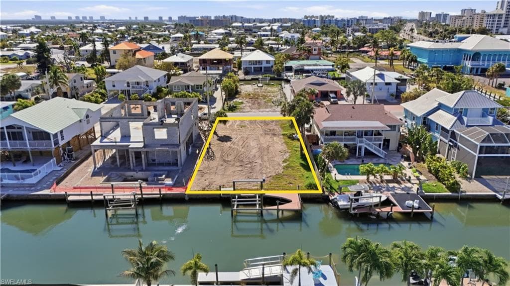 Aerial overview of property's location featuring property parcel outlined and skyline - Virtually Edited Image