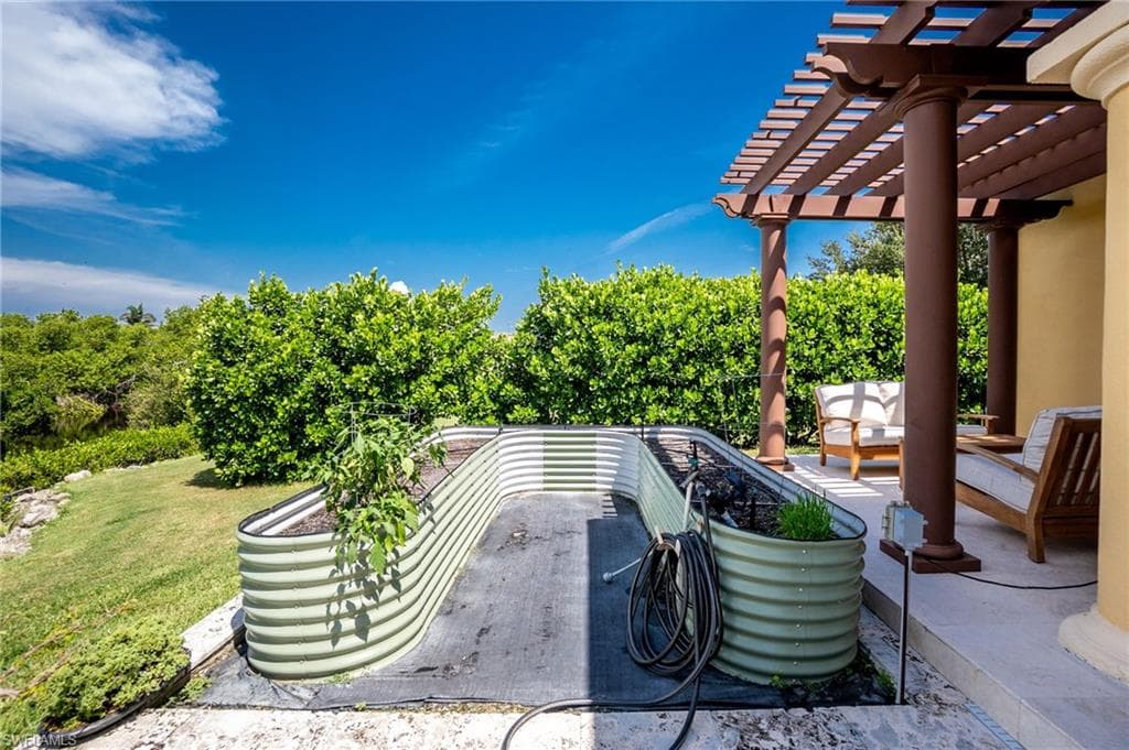 View of patio with outdoor furniture and a pergola