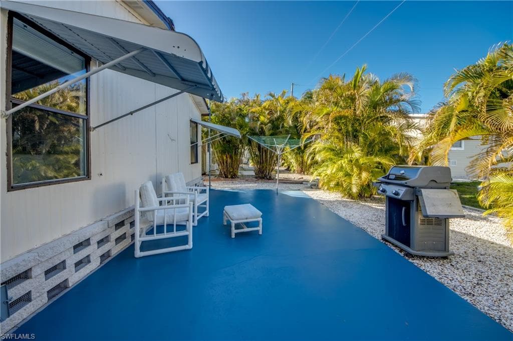 View of pool with a grill and patio surround