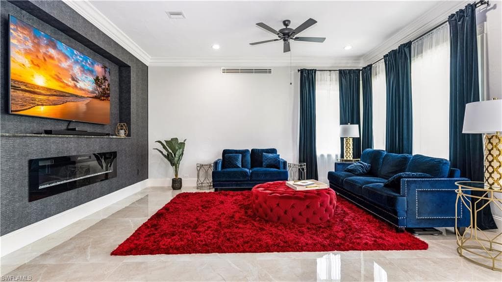 Living area with a fireplace, crown molding, and recessed lighting