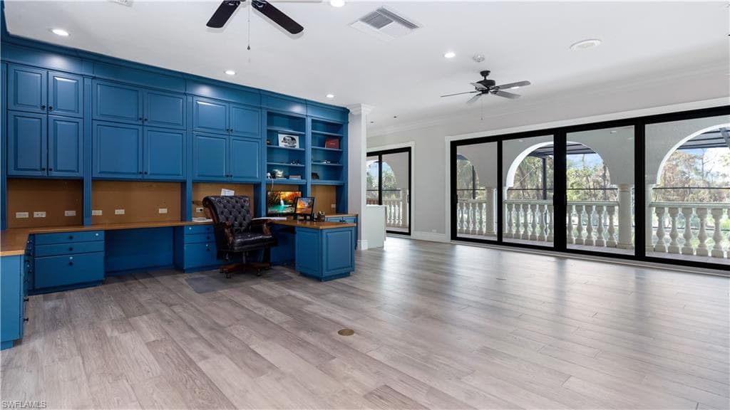 Unfurnished office featuring built in study area, a ceiling fan, recessed lighting, crown molding, and light wood-style flooring