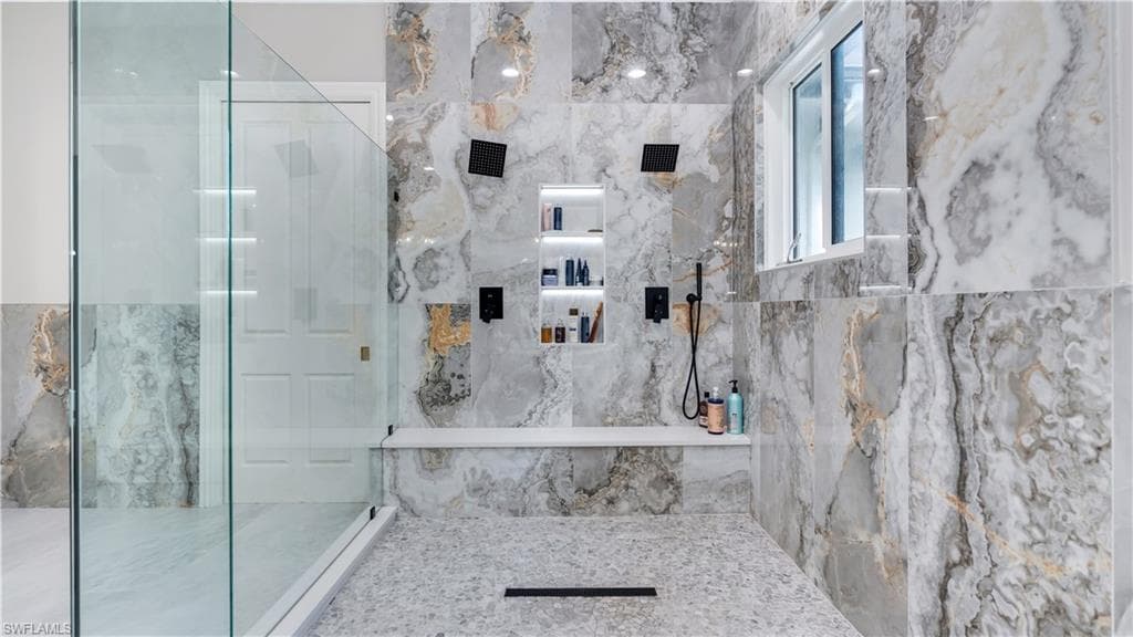 Bathroom featuring a marble finish shower