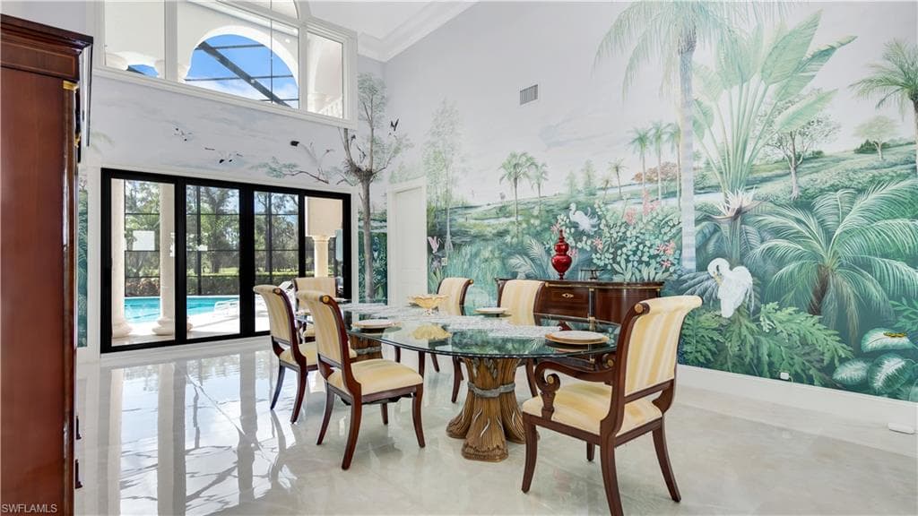 Dining space featuring a high ceiling and ornamental molding