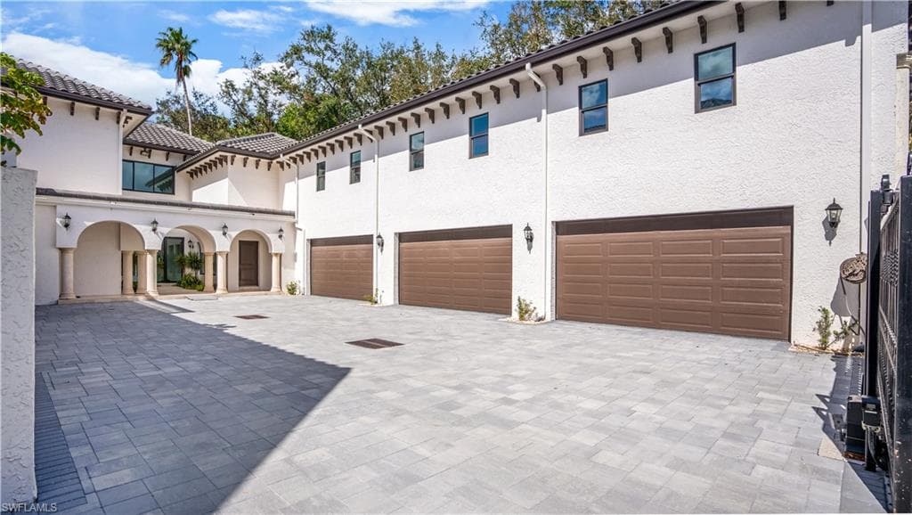 6 car garage with new pavers and hurricane grade garage doors