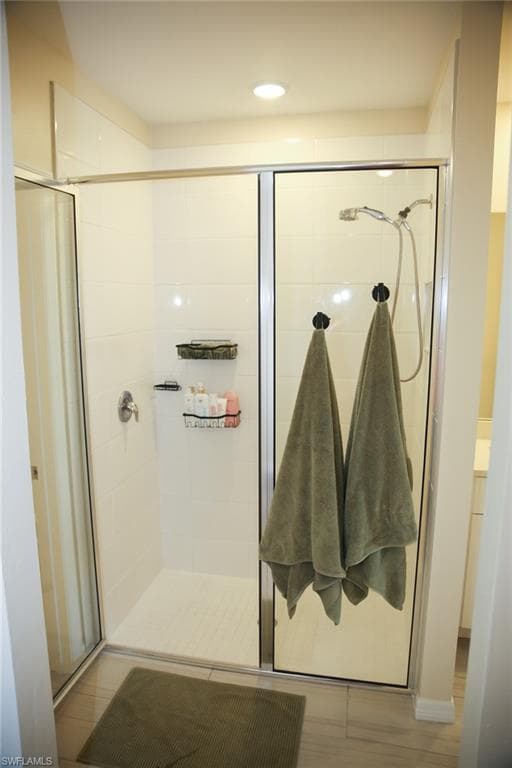 Bathroom featuring a shower stall, recessed lighting, vanity, and light wood-style floors