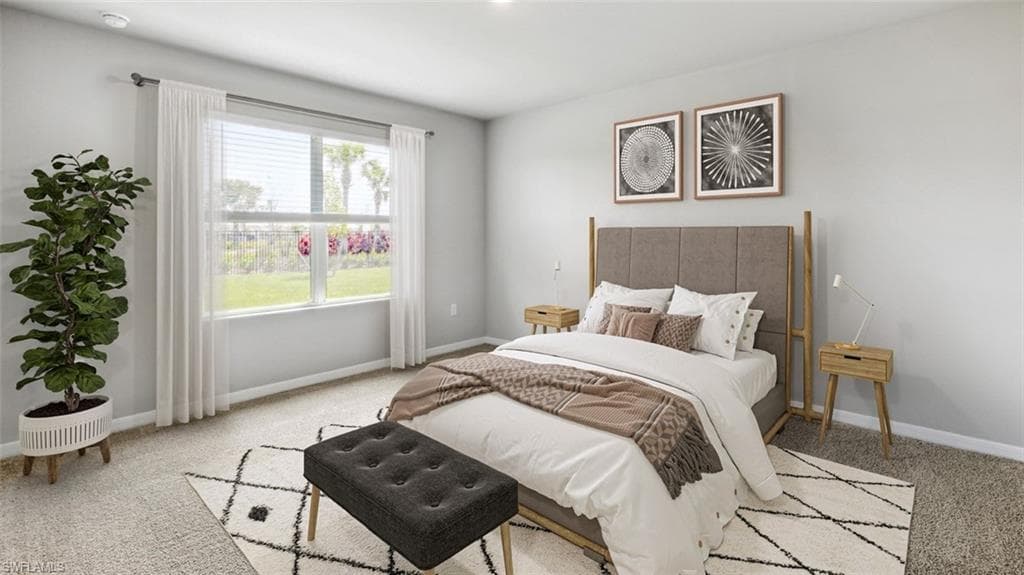 This image is virtually staged. Bedroom with light colored carpet