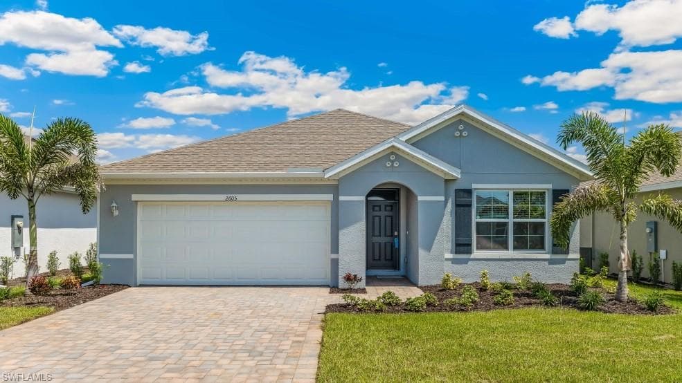 Model home. Single story home with a garage, decorative driveway, stucco siding, a front yard, and a shingled roof